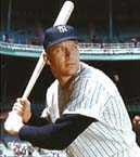 Color photo of Mickey Mantle posing in his right-handed batting stance at Yankee Stadium in New York