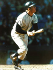 Color photo of Mickey Mantle watching his left-handed home run as it goes into the right-field stands at Yankee Stadium in New York
