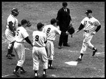 Mickey Mantle is greeted by Yogi Berra as he crosses the plate after belting his grand slam off Russ "Monk" Meyer in Game 5 of the 1953 World Series.